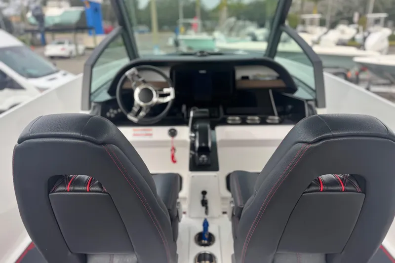  Yacht Photos Pics 2025 Monterey Elite 27 OB boat interior with steering wheel and dual seats.