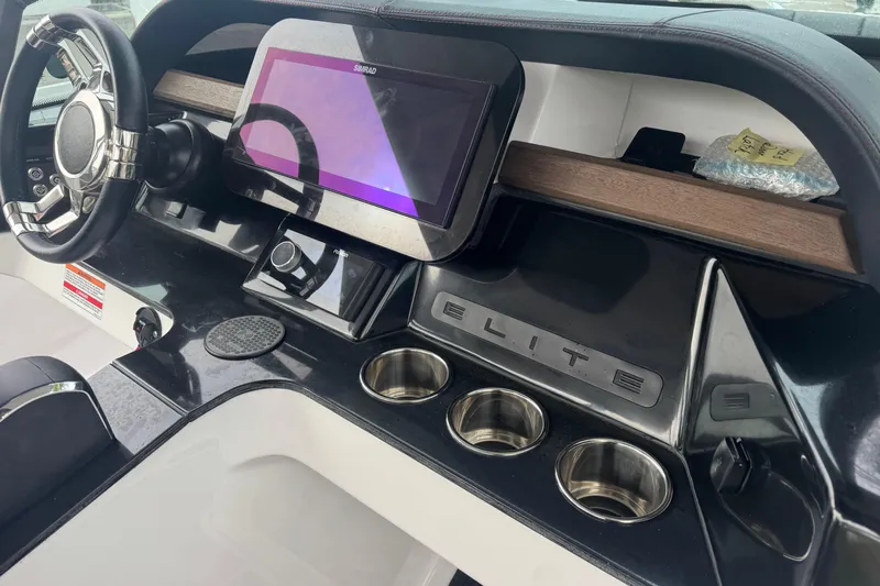  Yacht Photos Pics 2025 Monterey Elite 27 OB dashboard with steering wheel and touchscreen display.