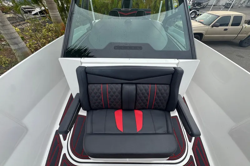  Yacht Photos Pics 2025 Monterey Elite 27 OB boat interior with black and red seating, sleek design.