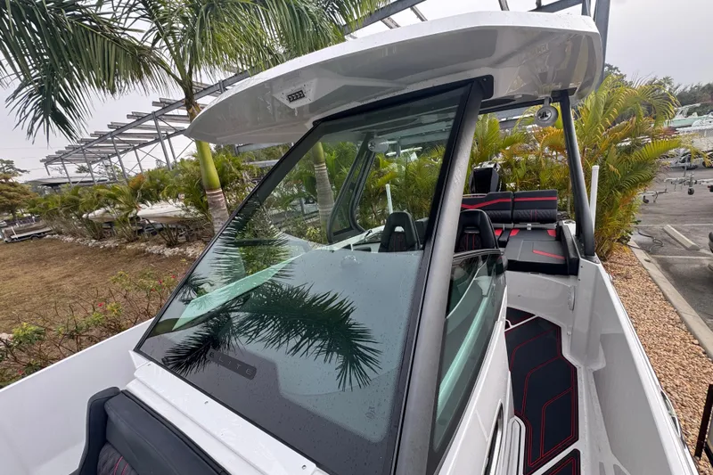  Yacht Photos Pics 2025 Monterey Elite 27 OB boat with sleek design, palm trees in background.