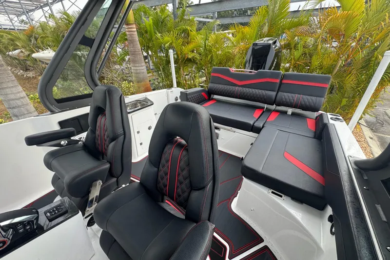  Yacht Photos Pics 2025 Monterey Elite 27 OB boat interior with black and red seating, modern design.