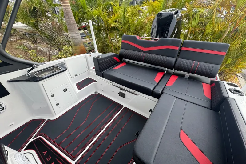  Yacht Photos Pics 2025 Monterey Elite 27 OB boat interior with black and red seating, sleek design.