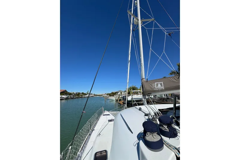 Betty Mae Yacht Photos Pics 2006 Lagoon 380 catamaran docked in a serene marina under clear blue skies.