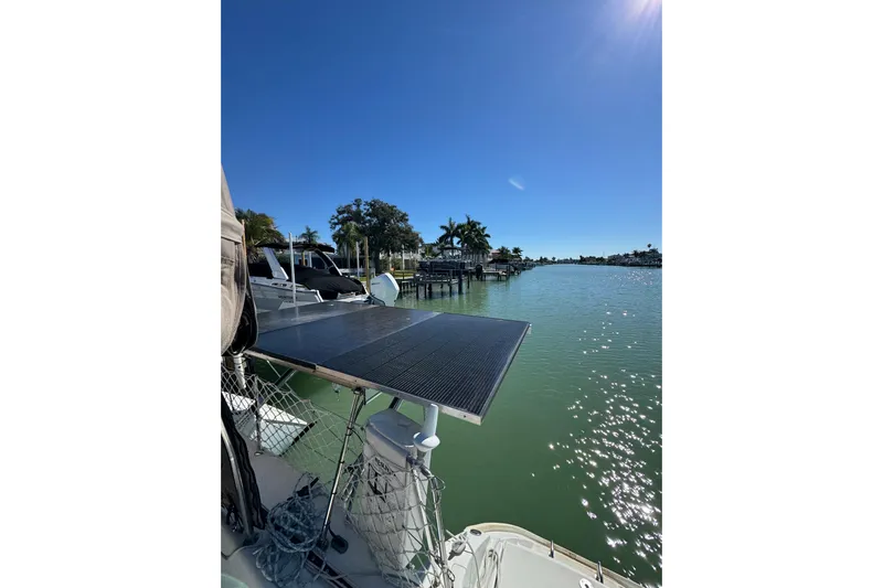 Betty Mae Yacht Photos Pics Lagoon 380 catamaran with solar panel, docked by a sunny waterfront, 2006 model.