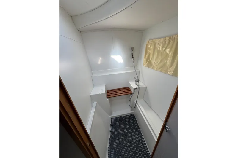 Betty Mae Yacht Photos Pics Bathroom interior of 2006 Lagoon 380 catamaran with shower and wooden seat.
