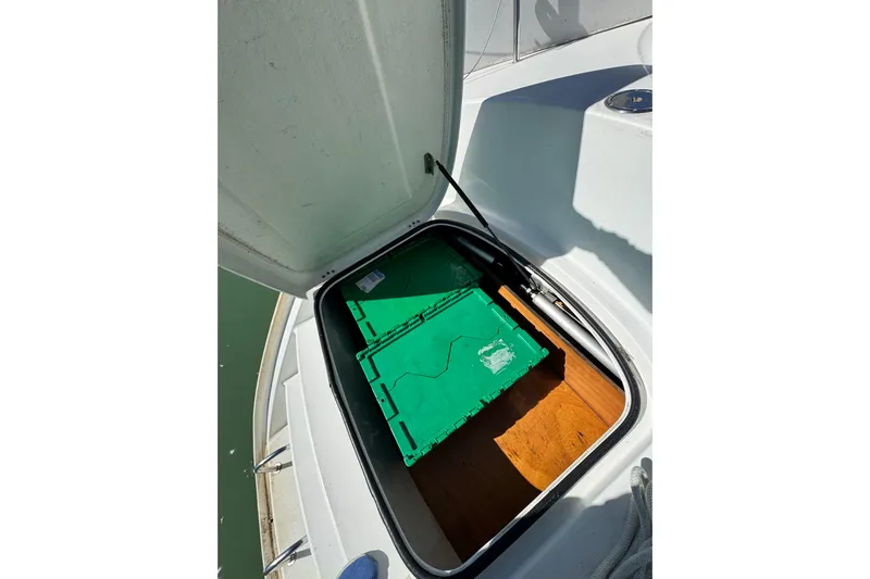Betty Mae Yacht Photos Pics Open storage compartment on 2006 Lagoon 380 catamaran with green containers inside.