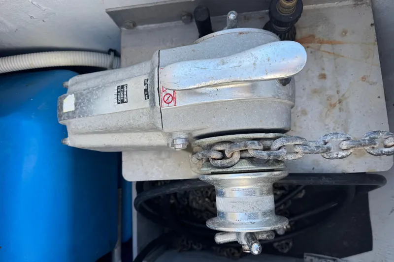 Betty Mae Yacht Photos Pics Anchor windlass on a 2006 Lagoon 380 catamaran with chain and blue tank.
