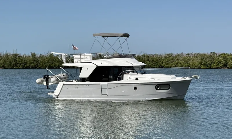 Seven Grand Yacht Photos Pics 2016 Beneteau Swift Trawler 30 cruising on calm waters with clear blue sky.