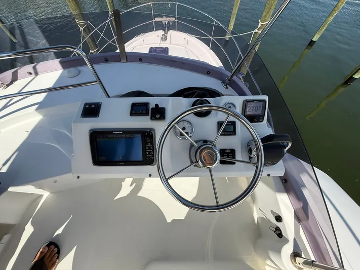 Seven Grand Yacht Photos Pics 2016 Beneteau Swift Trawler 30 helm with navigation equipment and steering wheel.