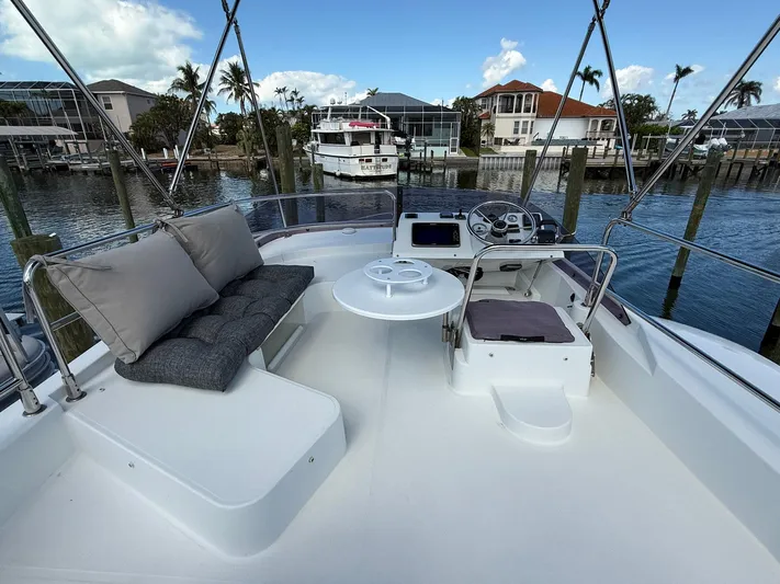 Seven Grand Yacht Photos Pics Flybridge of 2016 Beneteau Swift Trawler 30 with seating and helm, docked in a marina.