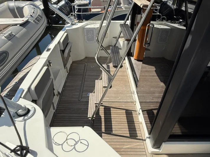 Seven Grand Yacht Photos Pics 2016 Beneteau Swift Trawler 30 deck with wooden flooring and metal stairs.