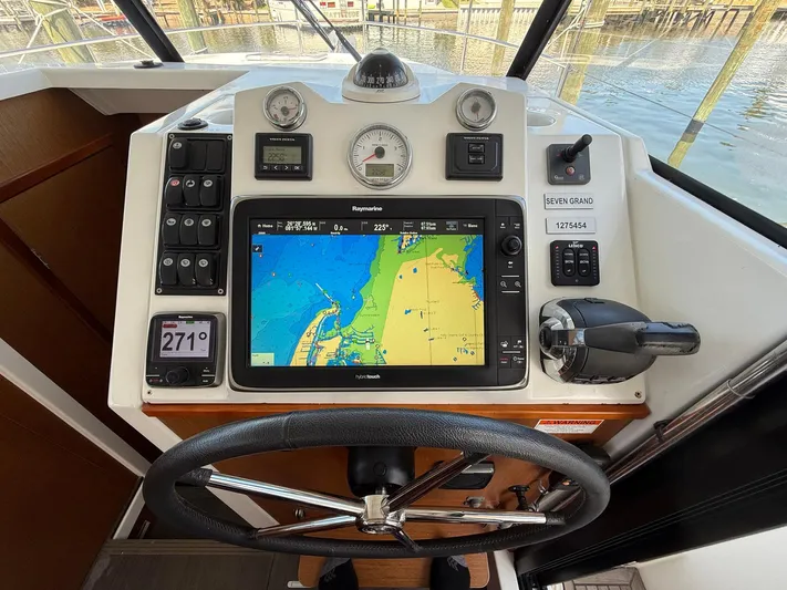 Seven Grand Yacht Photos Pics Helm of 2016 Beneteau Swift Trawler 30 with navigation system and controls.