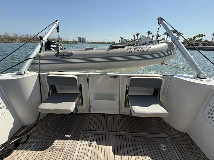 Seven Grand Yacht Photos Pics 2016 Beneteau Swift Trawler 30 with dinghy on davits, docked in sunny marina.