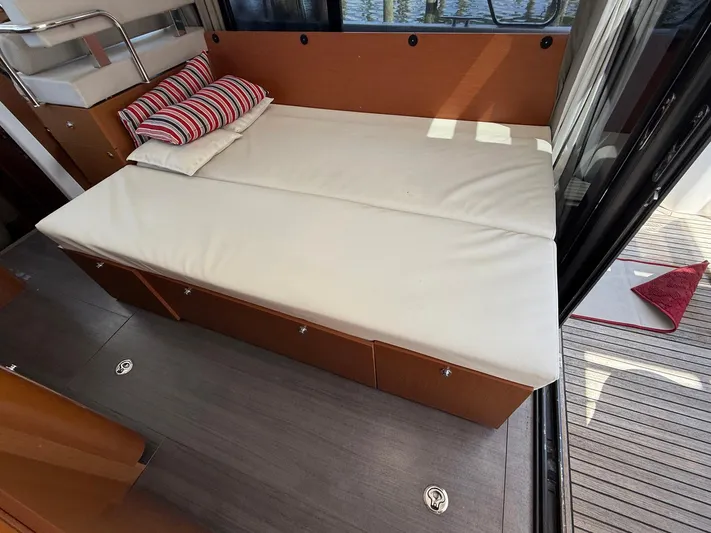 Seven Grand Yacht Photos Pics Interior view of 2016 Beneteau Swift Trawler 30 with a comfortable bed setup.