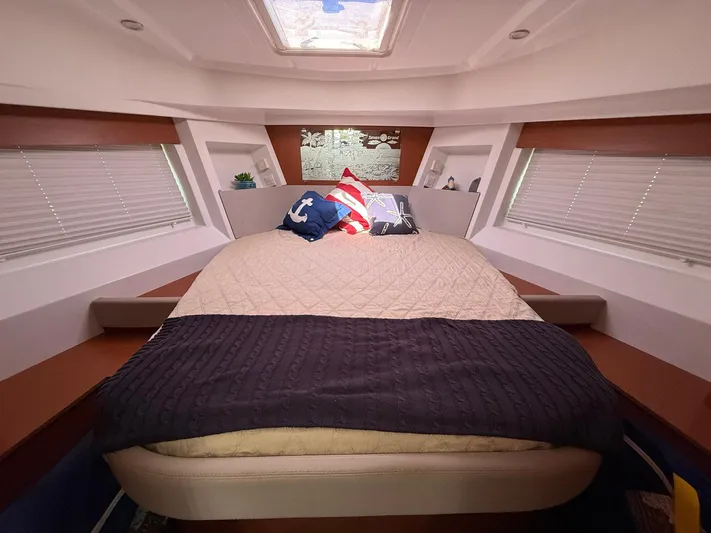 Seven Grand Yacht Photos Pics 2016 Beneteau Swift Trawler 30 interior cabin with cozy bed and nautical decor.