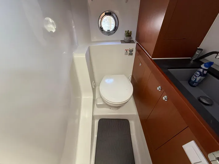 Seven Grand Yacht Photos Pics Bathroom interior of 2016 Beneteau Swift Trawler 30 with toilet and sink.