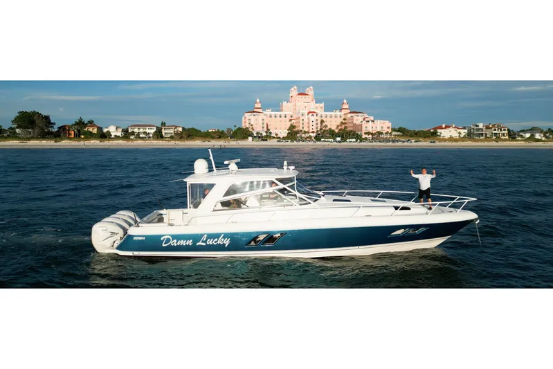 Damn Lucky Yacht Photos Pics 2019 Intrepid 475 Sport Yacht "Damn Lucky" cruising near a coastal resort.