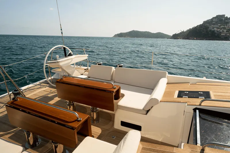 Invictus Yacht Photos Pics Luxurious 2023 Nautor Swan 55 yacht deck with elegant seating and ocean view.