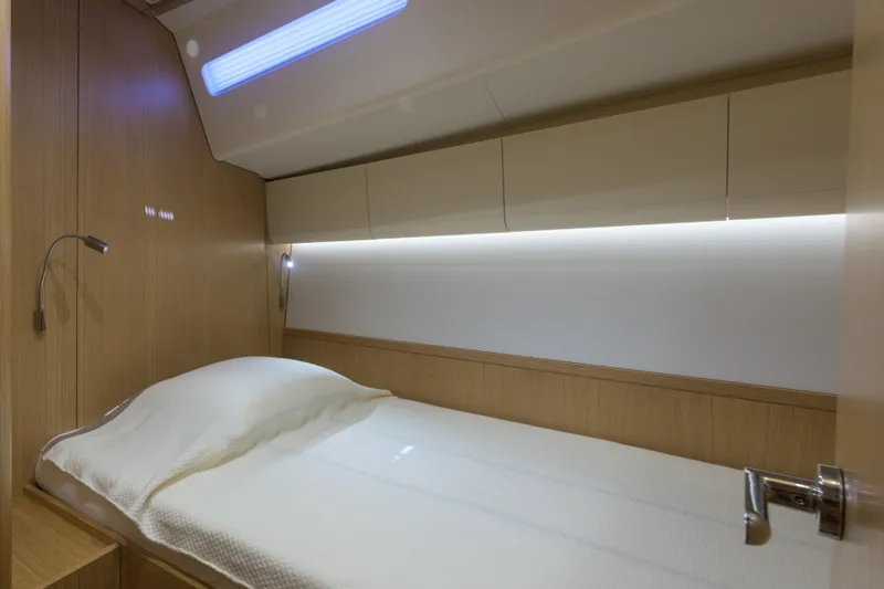 Invictus Yacht Photos Pics Luxurious cabin interior of 2023 Nautor Swan 55 yacht with modern lighting and wood finish.
