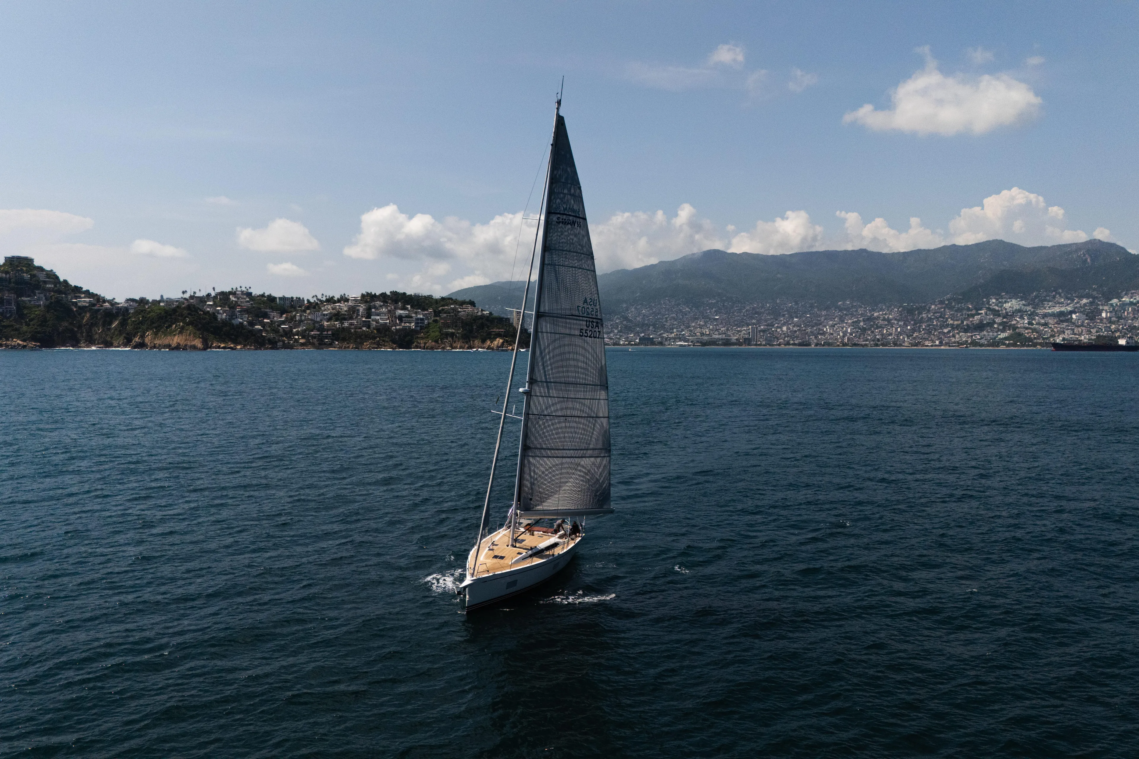 Invictus Yacht Photos Pics Swan 55 sailing in scenic coastal waters, 2023 Nautor Swan yacht.