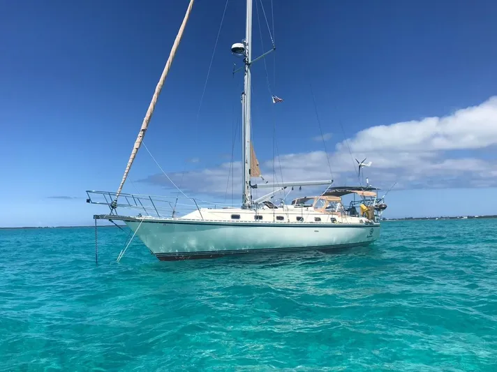 Agandau Yacht Photos Pics Sailboat Caliber 40LRC 2003 anchored in clear turquoise waters under a bright blue sky.