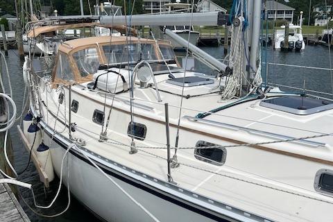 2003 Caliber 40LRC sailboat docked at a marina, featuring a sleek design and spacious deck.