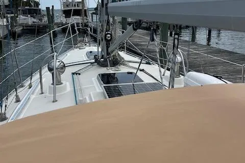 2003 Caliber 40LRC sailboat docked, featuring deck and solar panels.