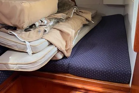 Agandau Yacht Photos Pics 2003 Caliber 40LRC interior cabin with stacked cushions and bedding.