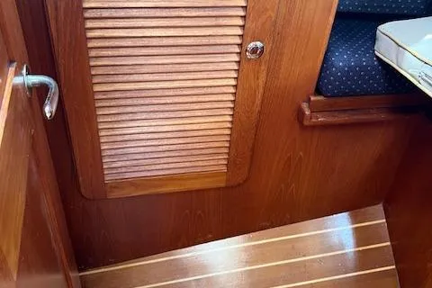 Agandau Yacht Photos Pics Wooden interior of a 2003 Caliber 40LRC boat with louvered door and seating area.