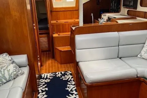Agandau Yacht Photos Pics Interior of a 2003 Caliber 40LRC yacht with wood finish and gray seating.