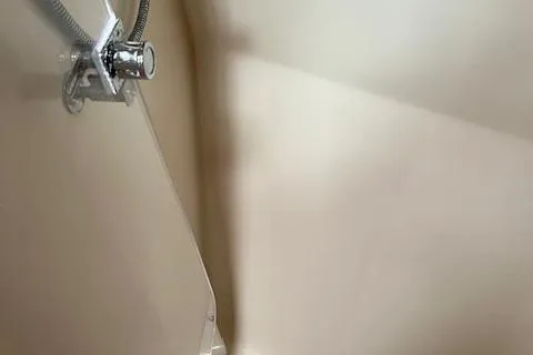 Agandau Yacht Photos Pics Shower area in a 2003 Caliber 40LRC boat, featuring a chrome showerhead.