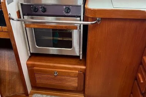 Agandau Yacht Photos Pics Wooden kitchen interior with built-in oven on a 2003 Caliber 40LRC yacht.