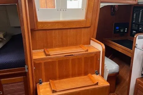 Agandau Yacht Photos Pics Interior of 2003 Caliber 40LRC sailboat with wooden cabinetry and navigation station.