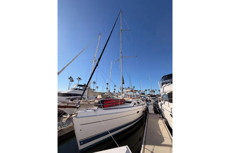 Thursday's Child Yacht Photos Pics Sailboat Hunter Passage 456, 2005 model, docked at marina under clear blue sky.