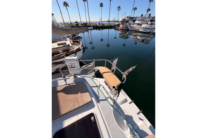 Thursday's Child Yacht Photos Pics Hunter Passage 456 sailboat docked in marina, reflecting palm trees, 2005 model.
