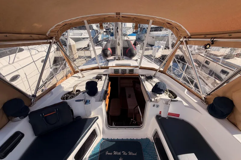 Thursday's Child Yacht Photos Pics Interior view of a 2005 Hunter Passage 456 sailboat cockpit with seating and navigation equipment.