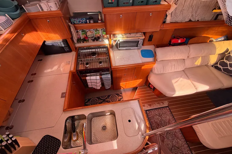 Thursday's Child Yacht Photos Pics Interior of 2005 Hunter Passage 456 yacht with kitchen and seating area.