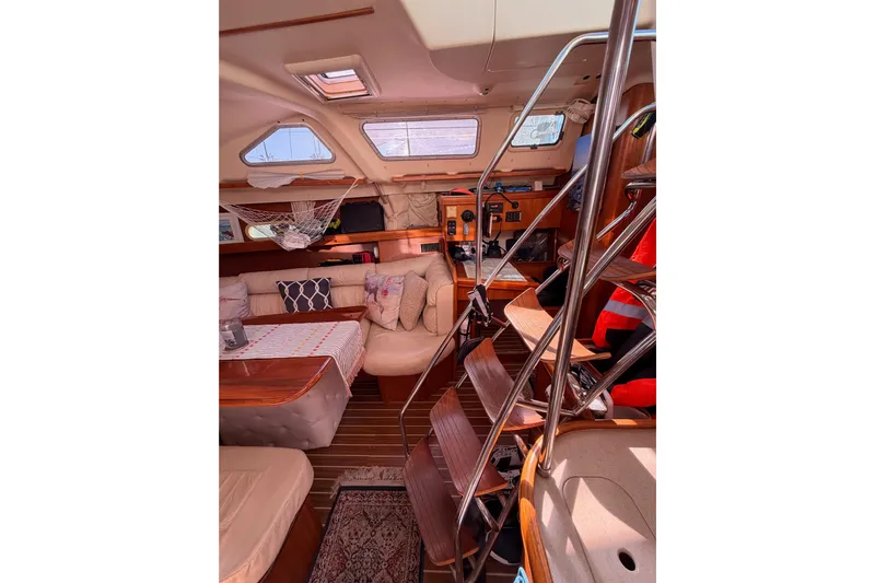 Thursday's Child Yacht Photos Pics Interior of 2005 Hunter Passage 456 yacht with cozy seating and wooden accents.