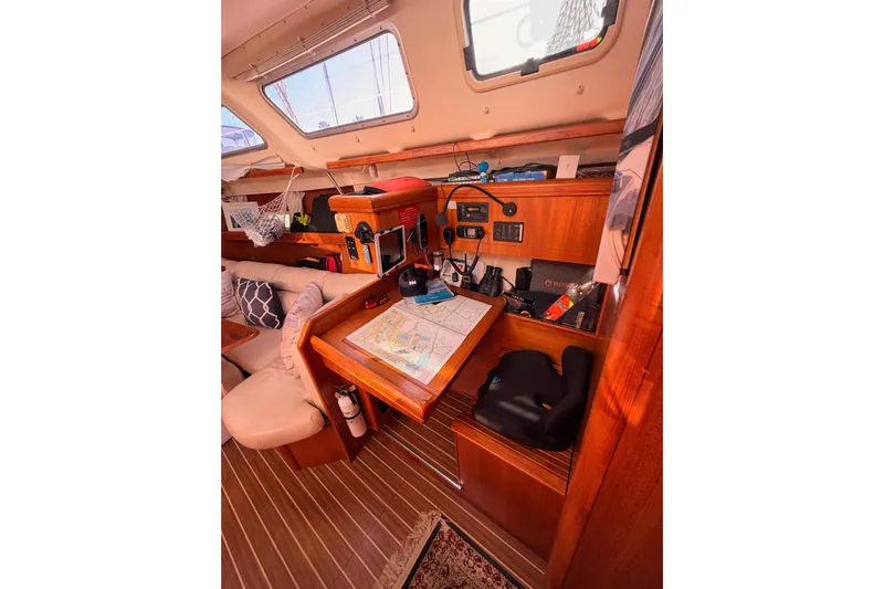 Thursday's Child Yacht Photos Pics Interior of 2005 Hunter Passage 456 sailboat with navigation station and cozy seating.