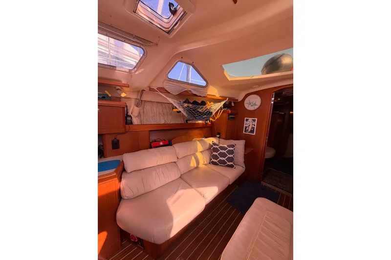 Thursday's Child Yacht Photos Pics Interior of 2005 Hunter Passage 456 yacht with cozy seating and skylights.