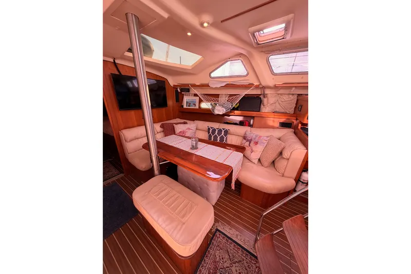 Thursday's Child Yacht Photos Pics Luxurious interior of 2005 Hunter Passage 456 yacht with cozy seating and elegant decor.