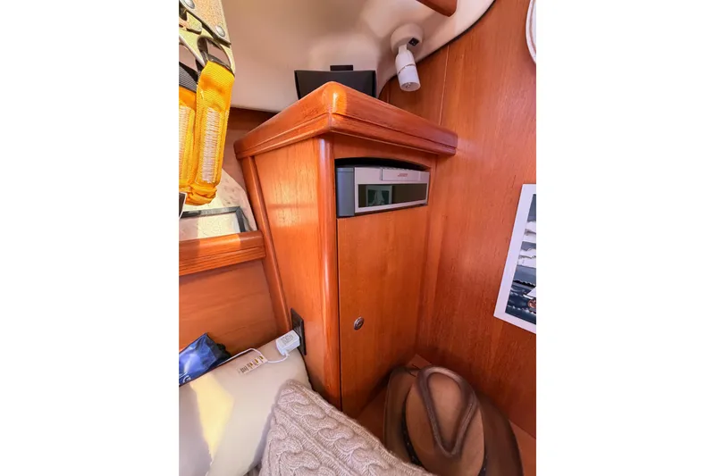Thursday's Child Yacht Photos Pics Interior of 2005 Hunter Passage 456 yacht with wooden cabinetry and Bose audio system.