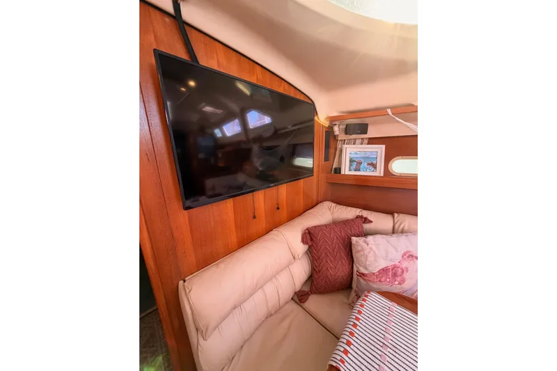 Thursday's Child Yacht Photos Pics Interior of 2005 Hunter Passage 456 yacht with TV and cozy seating area.