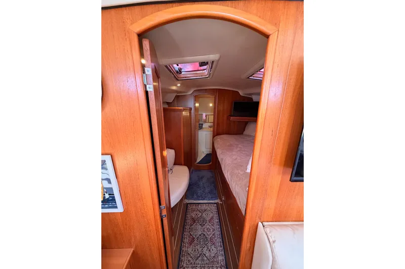 Thursday's Child Yacht Photos Pics Interior view of 2005 Hunter Passage 456 yacht cabin with wood finish and cozy furnishings.