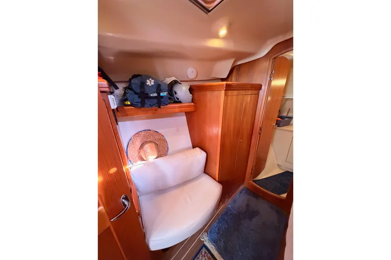 Thursday's Child Yacht Photos Pics Interior of 2005 Hunter Passage 456 yacht with wooden cabinetry and seating area.