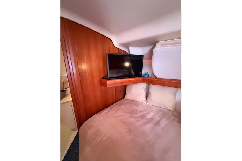 Thursday's Child Yacht Photos Pics Cozy cabin interior of 2005 Hunter Passage 456 yacht with TV and wooden paneling.