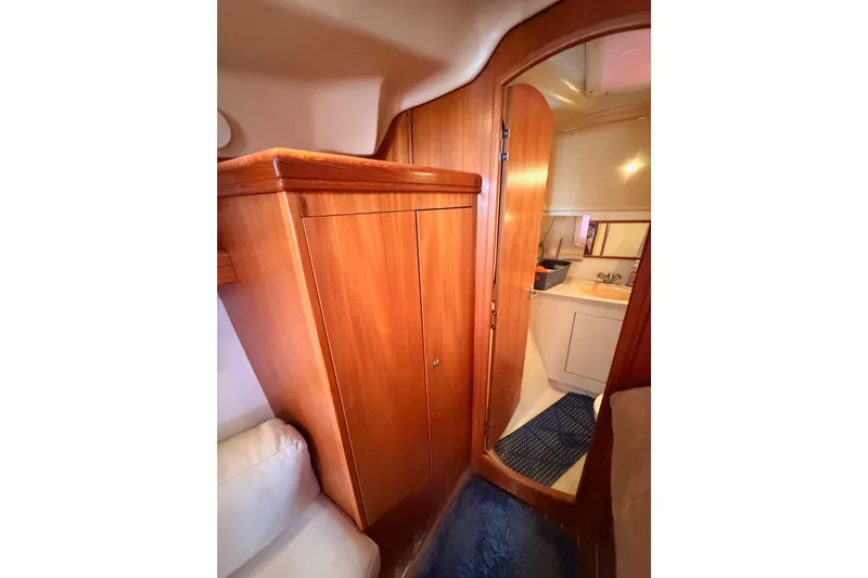 Thursday's Child Yacht Photos Pics Interior of 2005 Hunter Passage 456 yacht showing wooden cabinetry and bathroom entrance.