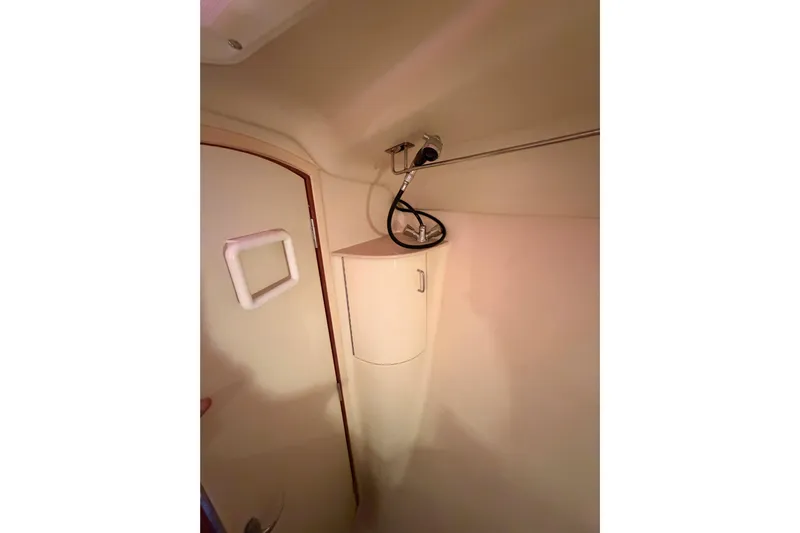 Thursday's Child Yacht Photos Pics Interior of 2005 Hunter Passage 456 yacht bathroom with shower and storage cabinet.