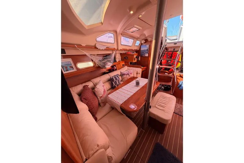 Thursday's Child Yacht Photos Pics Interior of 2005 Hunter Passage 456 yacht with cozy seating and wooden accents.