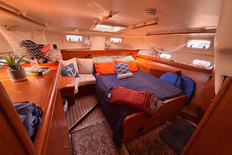 Thursday's Child Yacht Photos Pics Cozy cabin interior of 2005 Hunter Passage 456 yacht with bed and nautical decor.